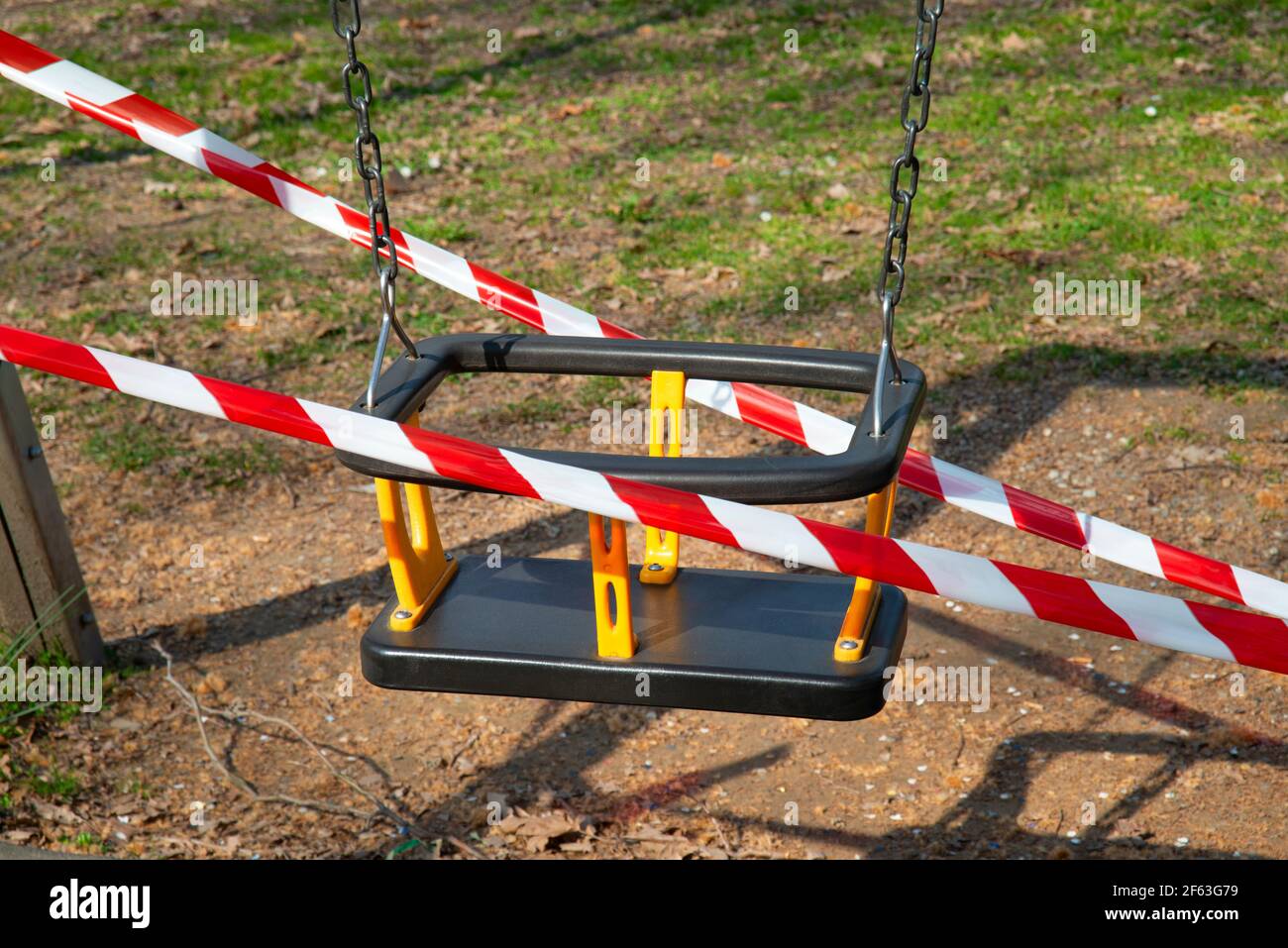 Italy, Lombardy, Crema, Park Children Playground  Closed due to the Covid-19 Virus with a Barrier Tape Stock Photo