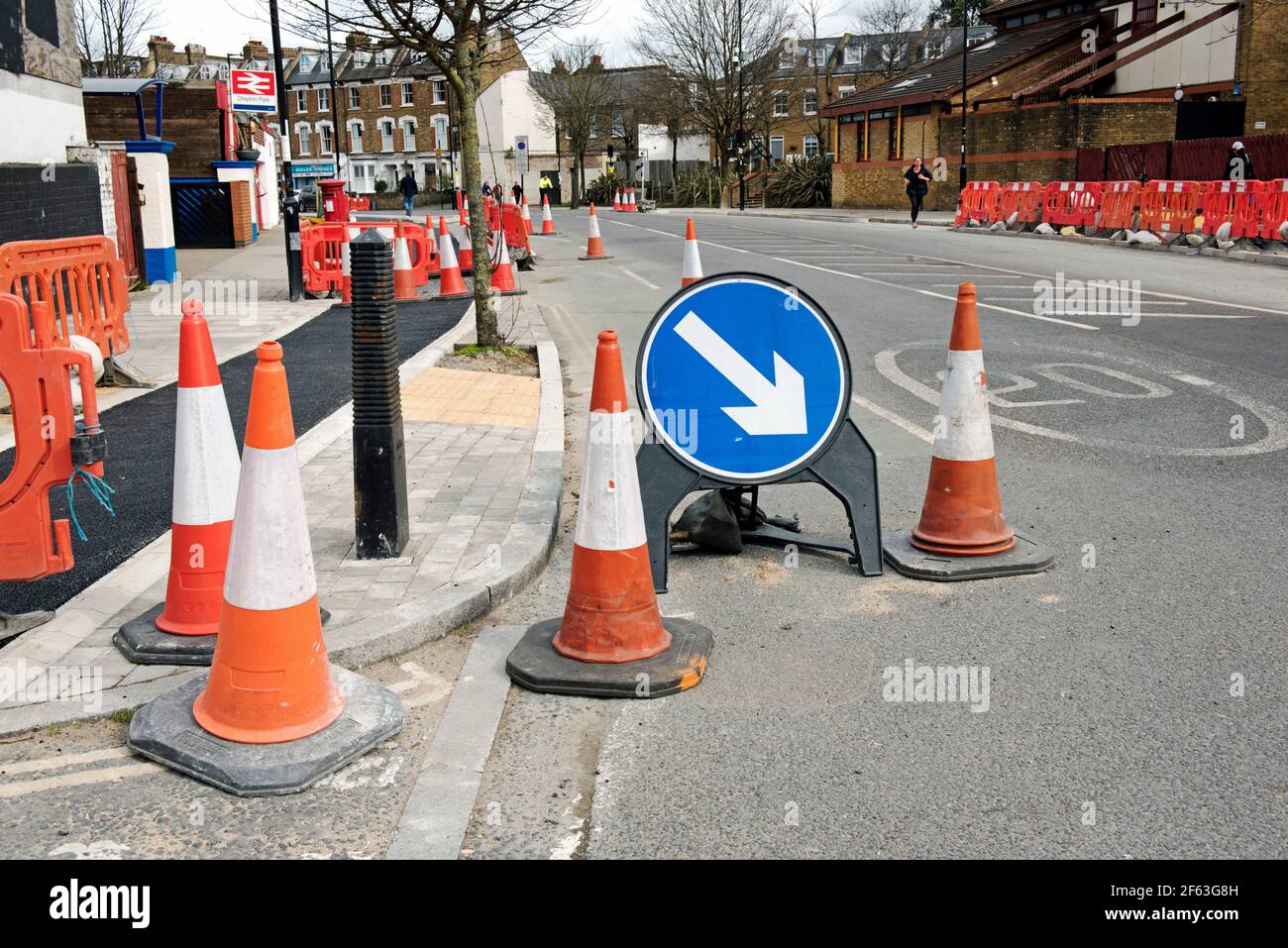 Road Works with cones and arrow direction sign constructing cycle lanes part of the low traffic neighbourhood scheme Drayton Park Highbury Stock Photo
