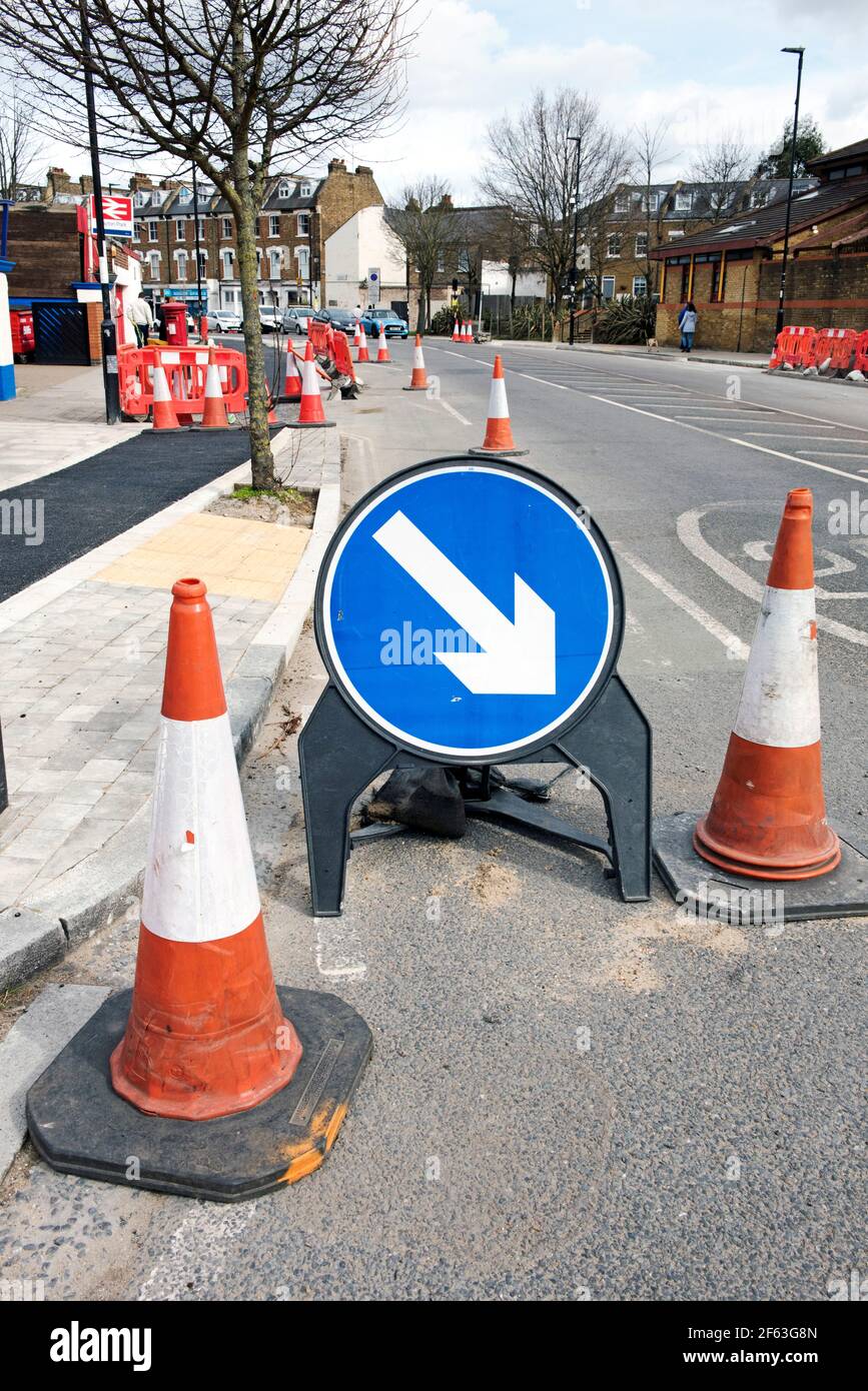 Road Works with cones and arrow direction sign constructing cycle lanes