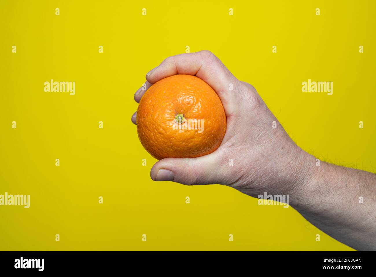 An orange in the hand Stock Photo