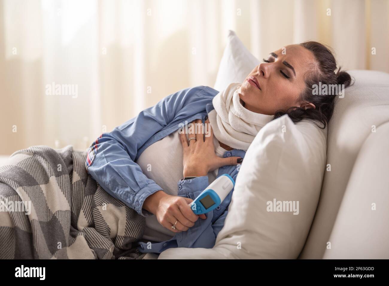 Ill woman experiencing breathing and cough problems while holding