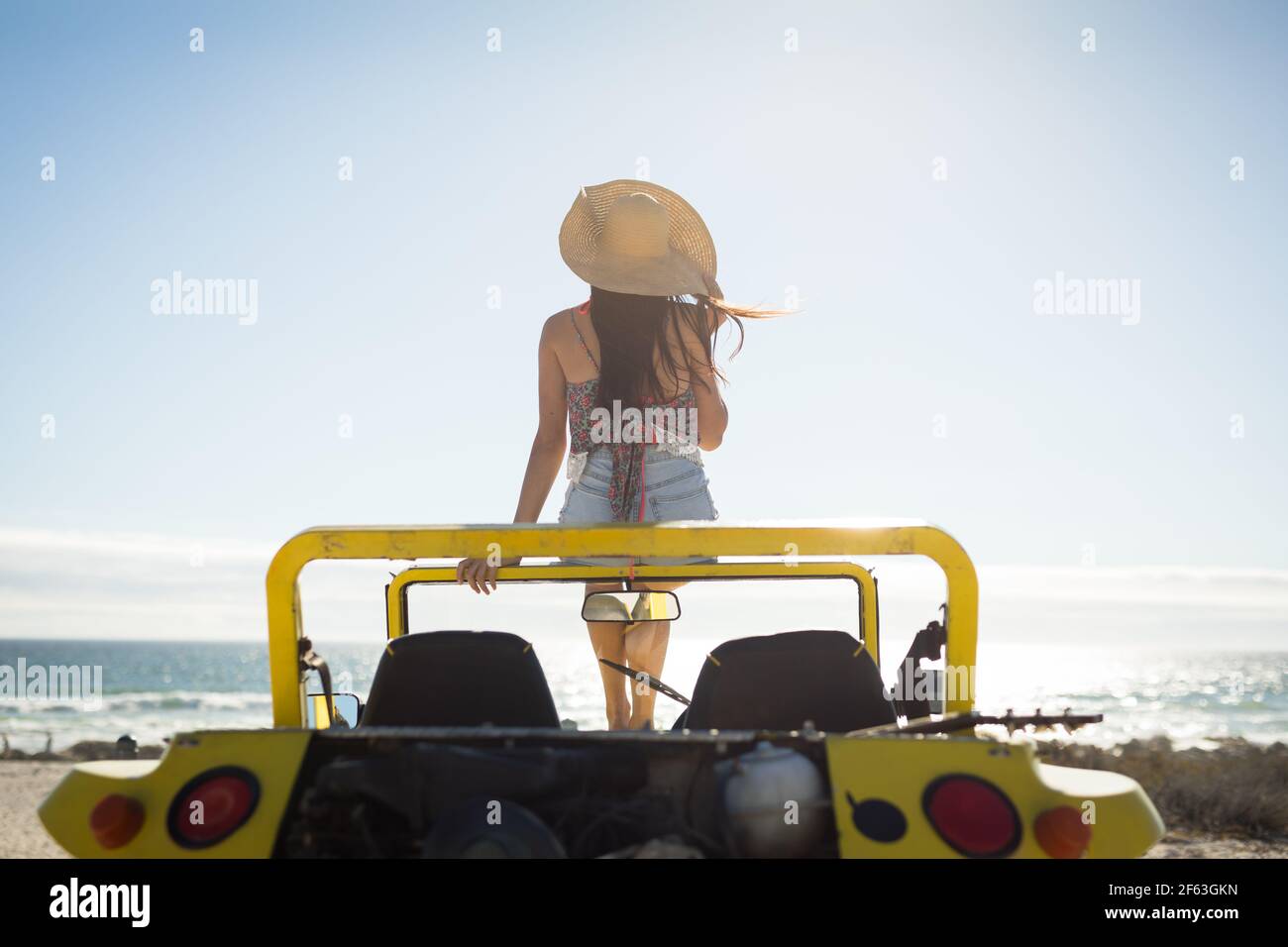 Caucasian woman sitting on beach buggy 