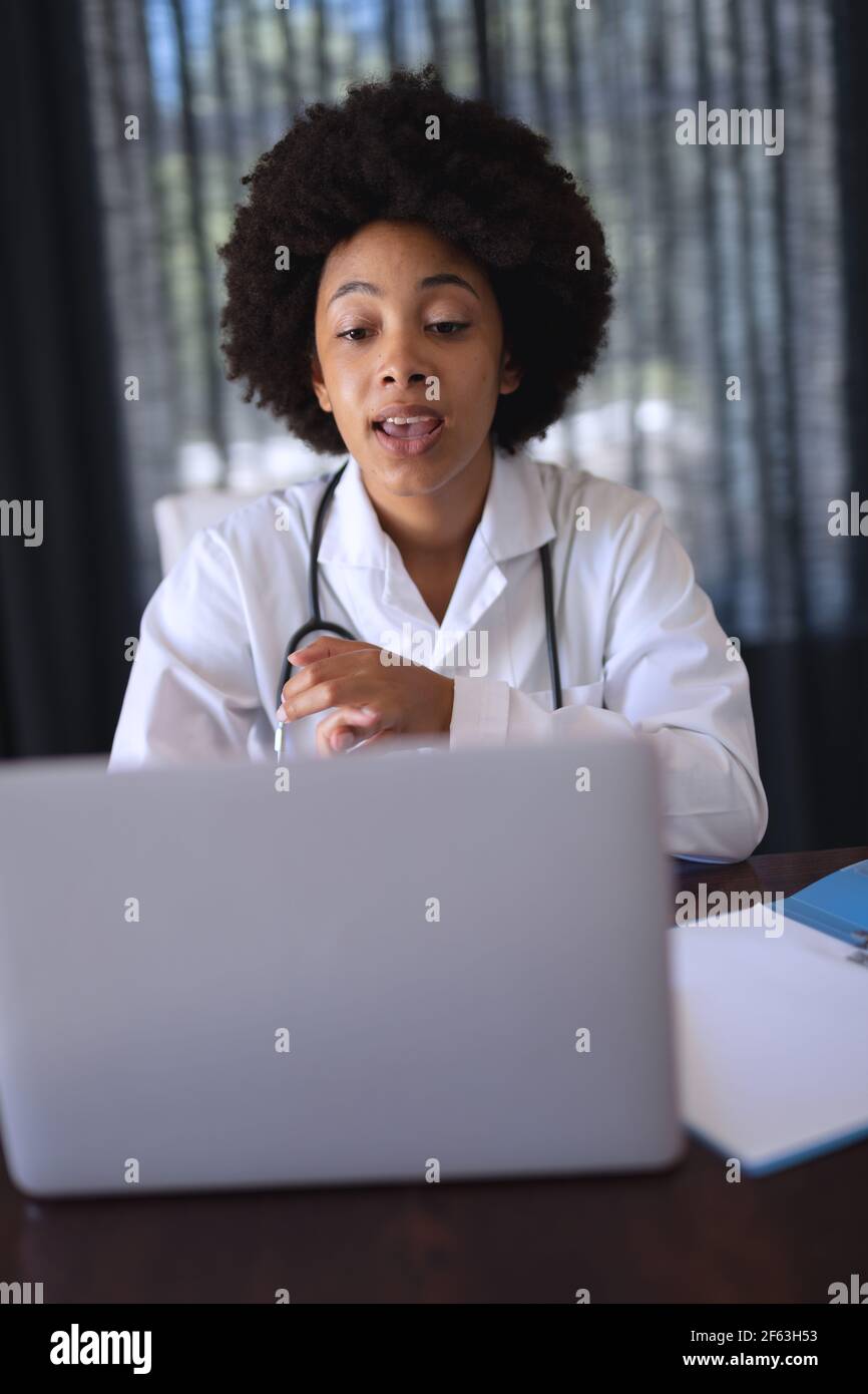African american female doctor sitting making video call consultation Stock Photo