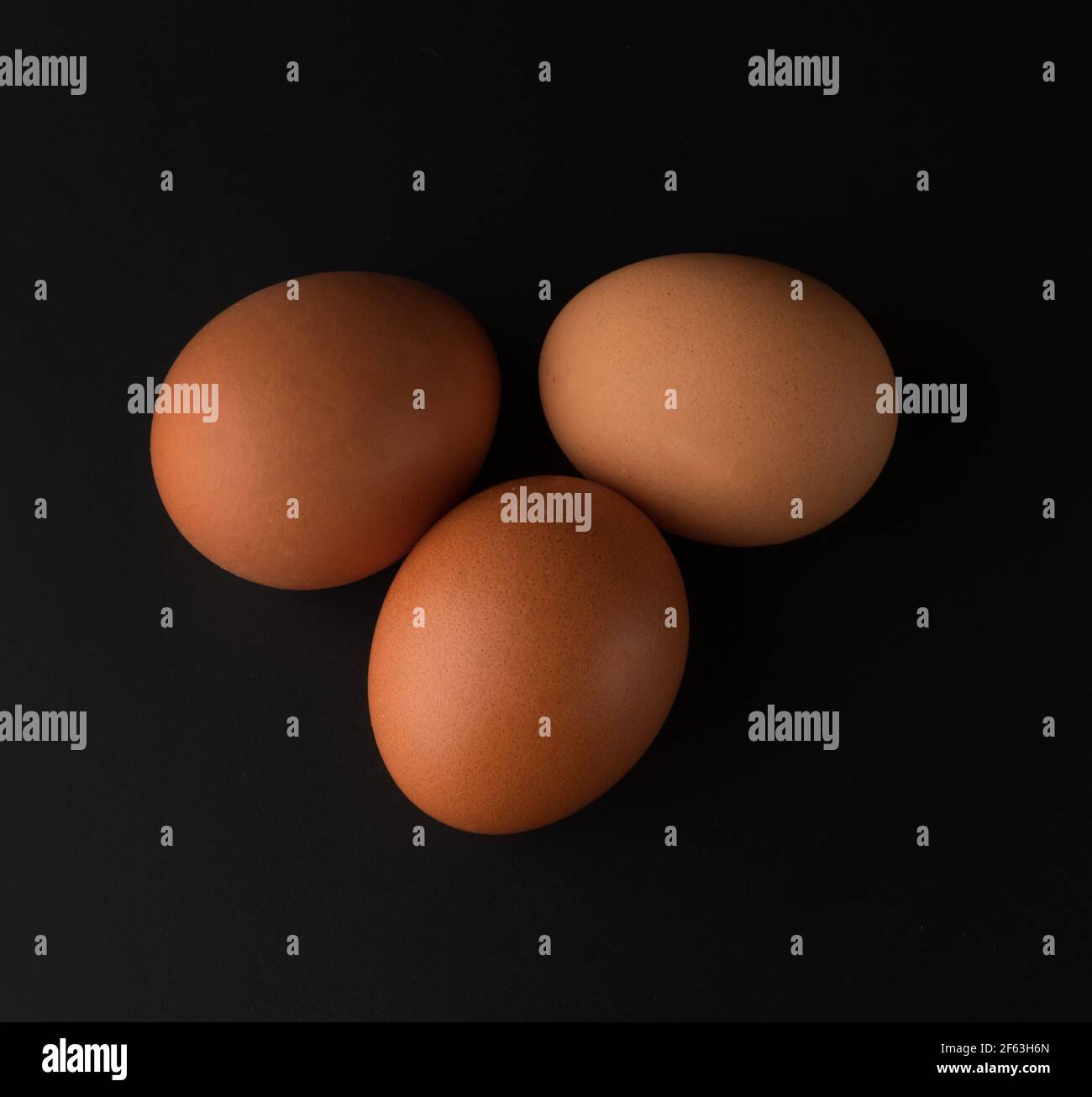 chicken eggs on black background Stock Photo - Alamy