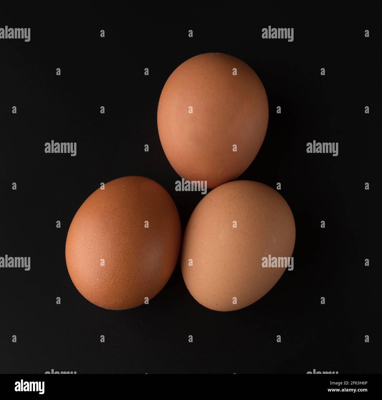 chicken eggs on black background Stock Photo - Alamy