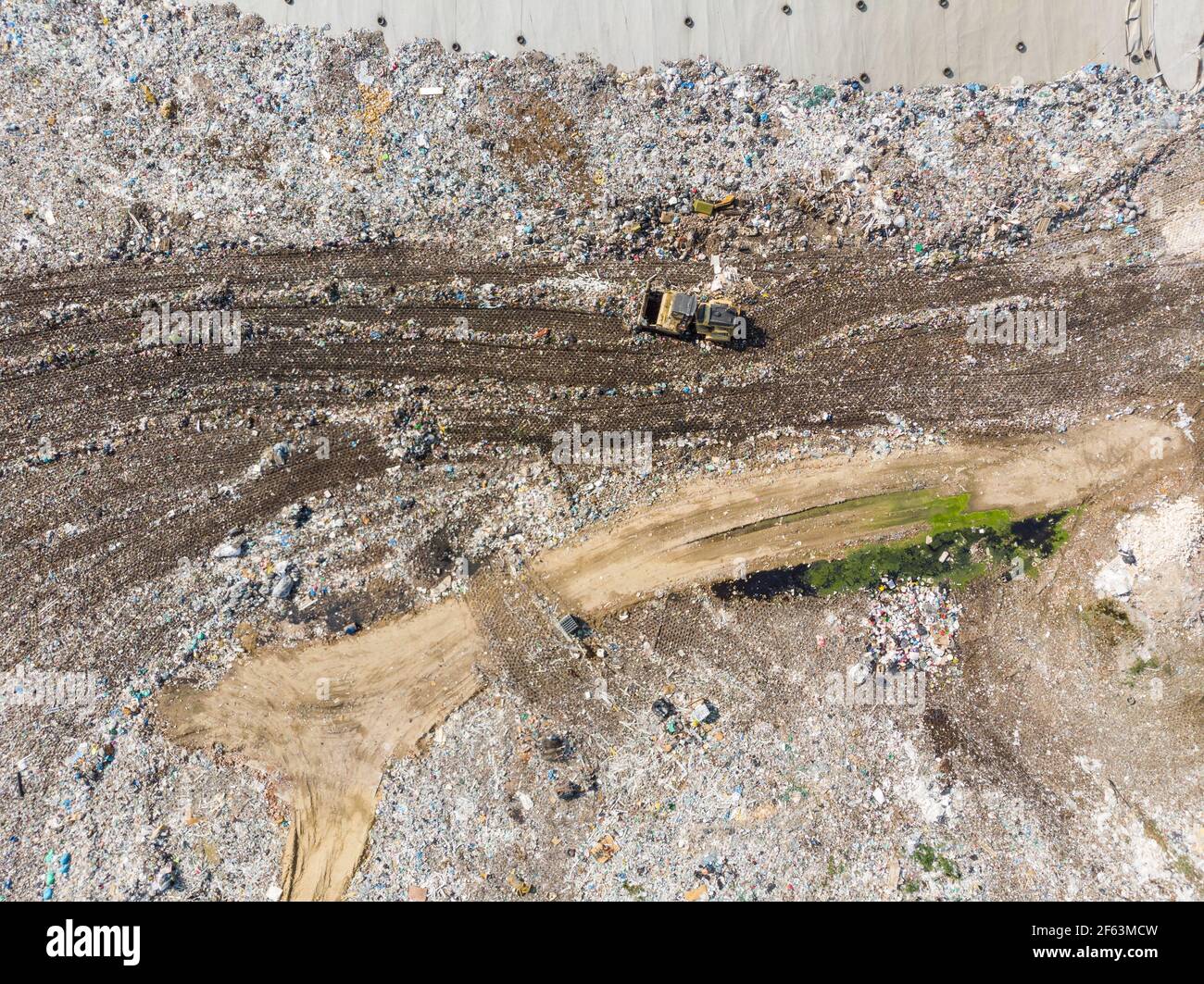 Garbage trucks unload garbage to a landfill Stock Photo Alamy