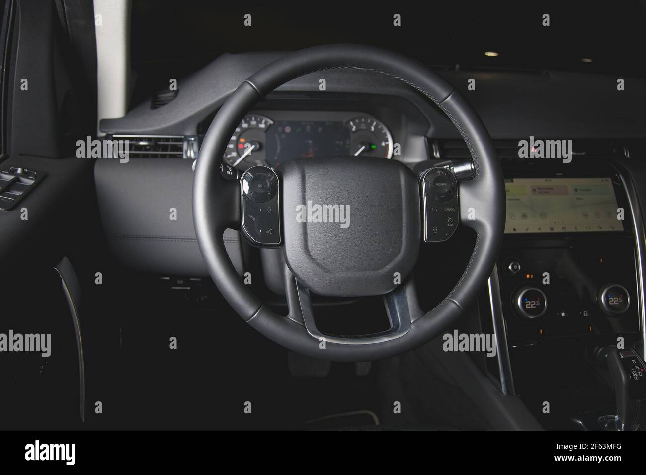 Multifunction steering wheel in leather car interior at night Stock