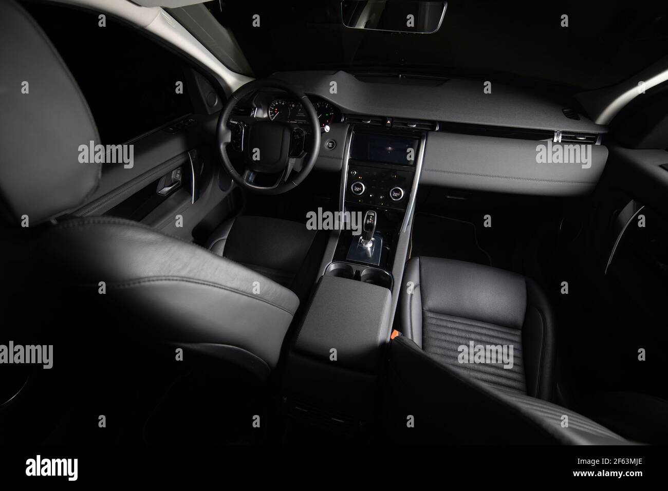 Dark luxury car Interior. Front seats of premium suv Leather panels