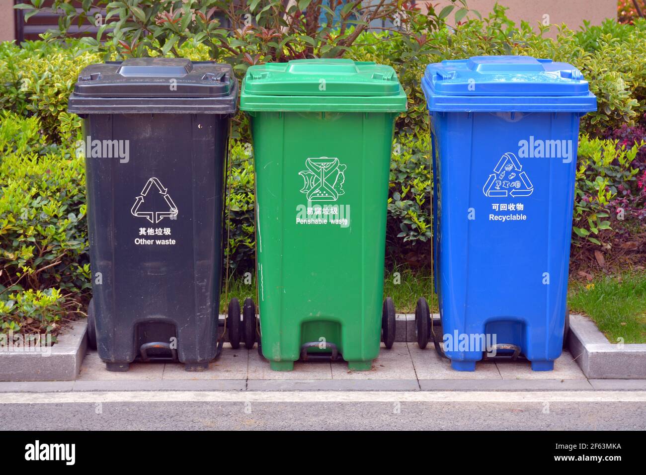 3 Coloured bins for rubbish and recycling in China. Different than the rest of the world they use blue as recycle not green. Stock Photo