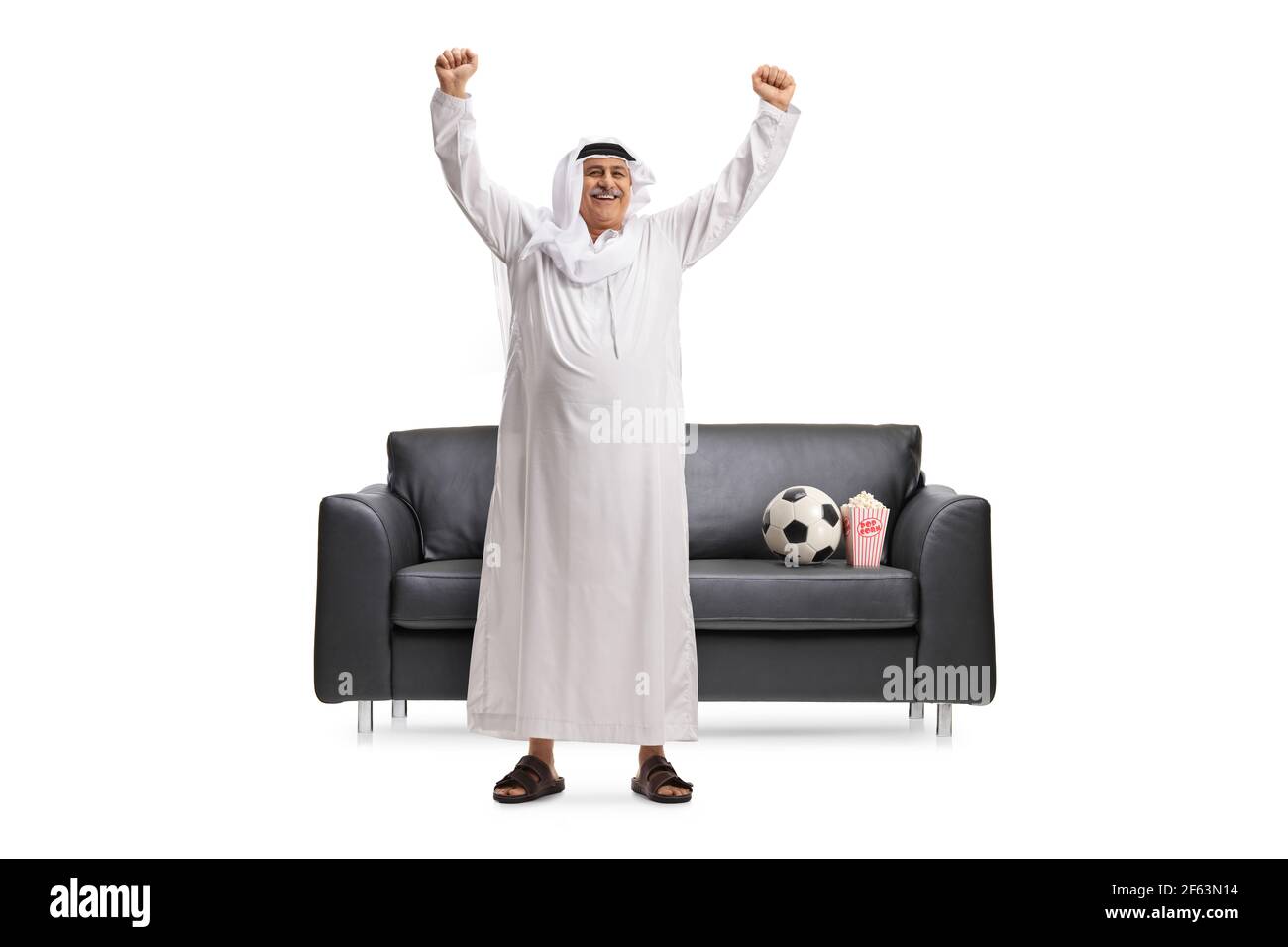 Full length portrait of an arab man cheering and watching football in ...