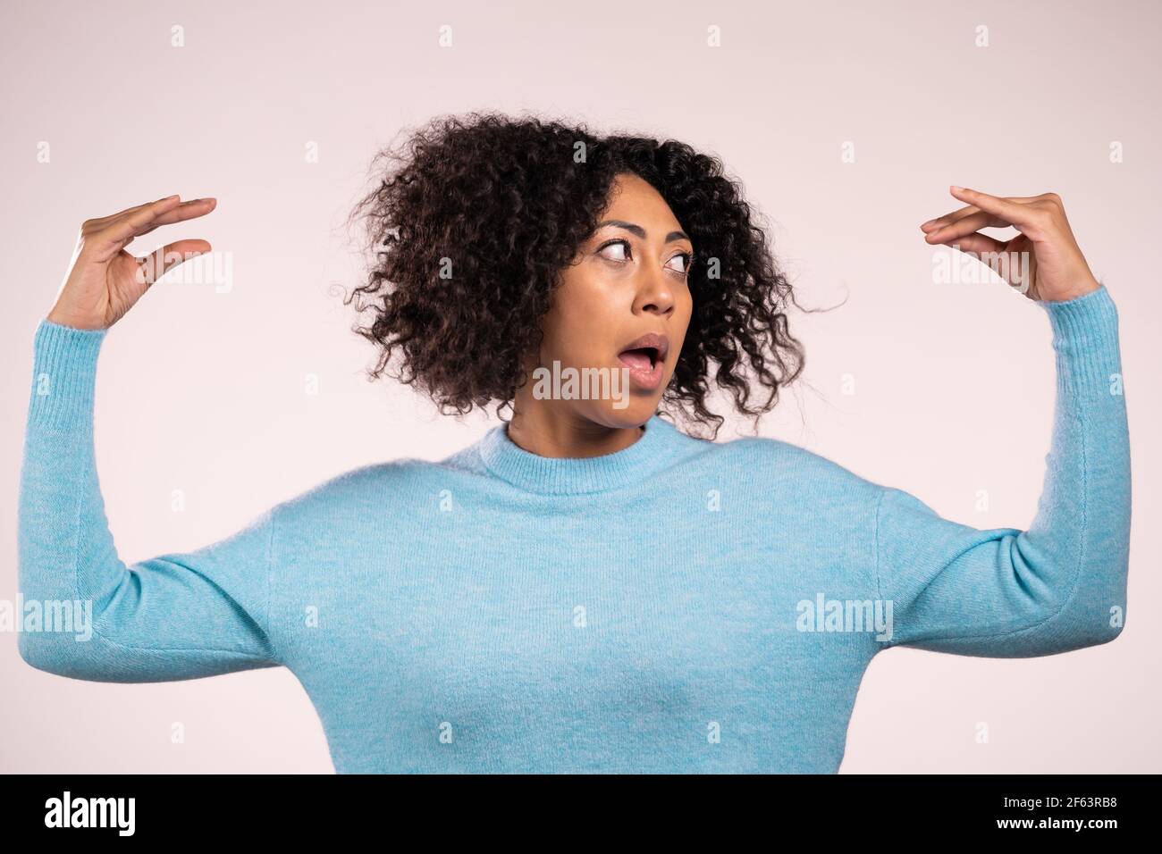 Pretty african woman showing blablabla gesture with hands and rolling