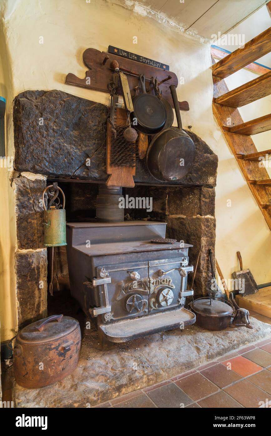 Marksman cast iron woodburning stove in granite fireplace in dining