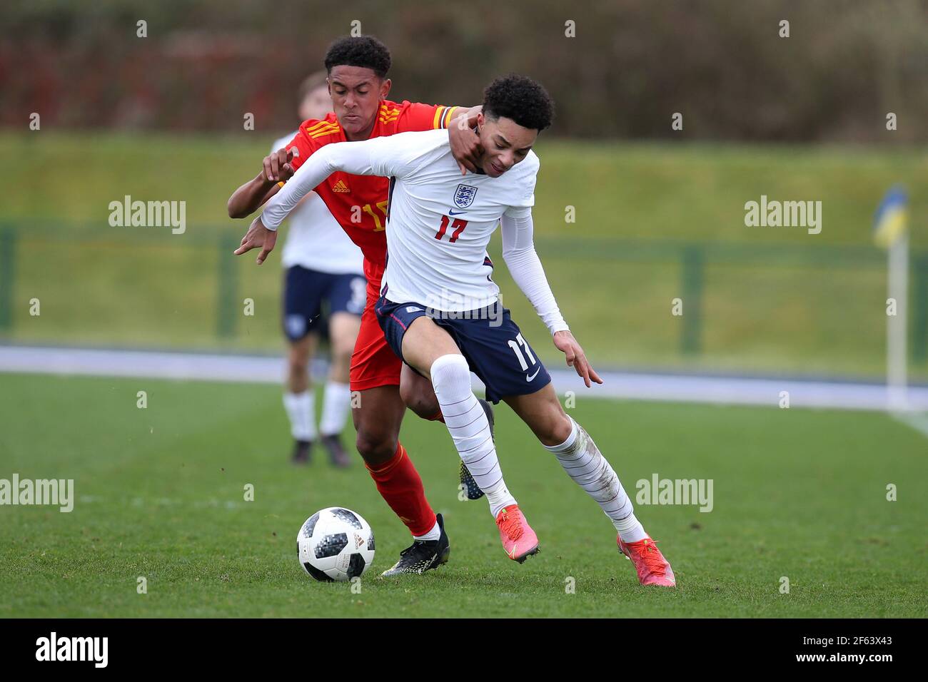 Cardiff, UK. 29th Mar, 2021. Samuel Edozie of England u18's and Zac Bell of Wales u18's (l) in action. U18 Football international match, Wales v England, at the Leckwith stadium in Cardiff, South Wales on Monday 29th March 2021. Editorial use only. pic by Andrew Orchard/Andrew Orchard sports photography/Alamy Live News Credit: Andrew Orchard sports photography/Alamy Live News Stock Photo