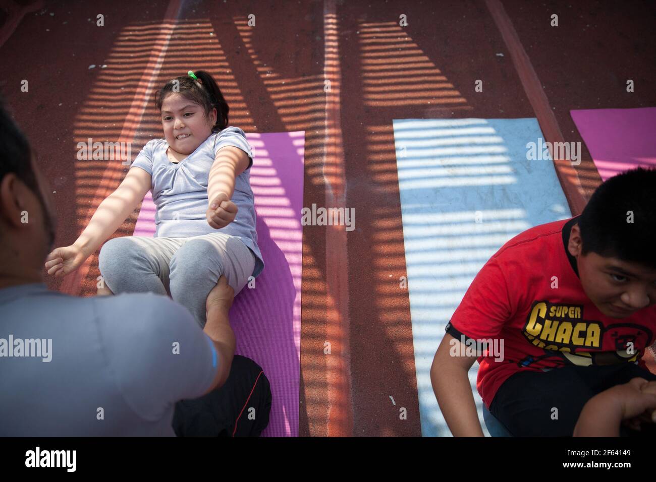 Anie Alexandra Rosas Gutierrez, a 9-year-old Mexican girl with obesity, attends a workout program to learn about how to stay healthy with the goal of losing weight and prevent morbid obesity, at the obesity clinic at the Federico Gomez Children’s Hospital in Mexico City, Mexico on June 26, 2015. Anie weighs 104 pounds and is 143 centimeters tall. Photograph by Bénédicte Desrus Stock Photo