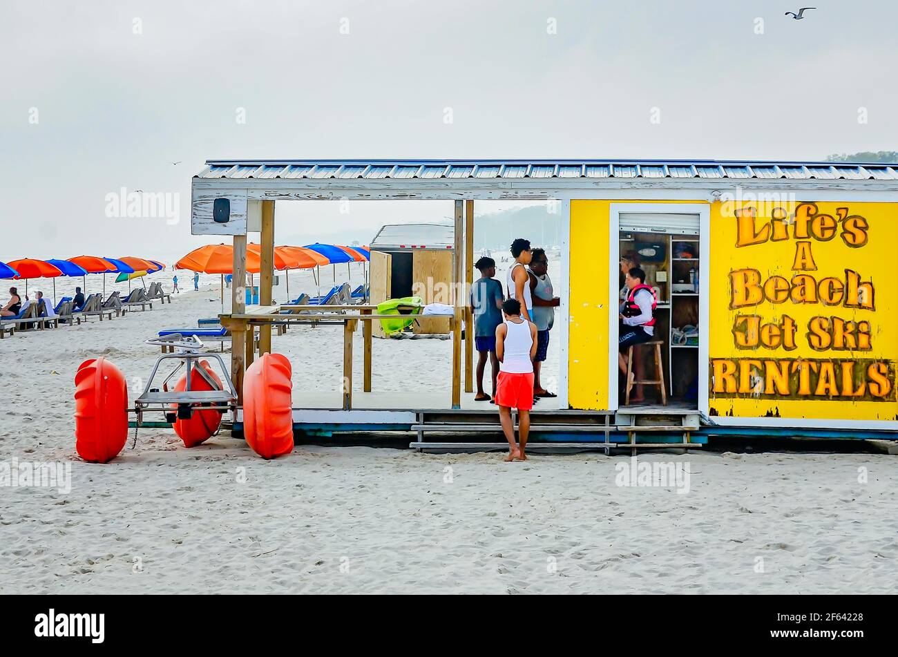 Tourists stand in line to rent jet skis at Life’s a Beach jet ski rentals on Biloxi Beach, March 27, 2021, in Biloxi, Mississippi. Stock Photo