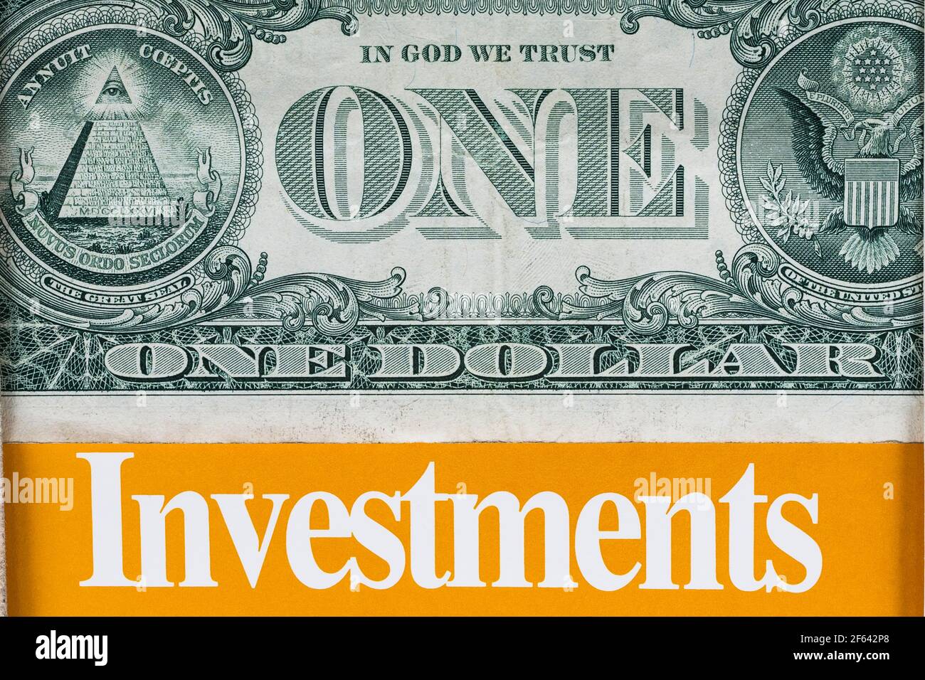 US one dollar paper currency banknote above the word Investments in bold white letters on orange background Stock Photo