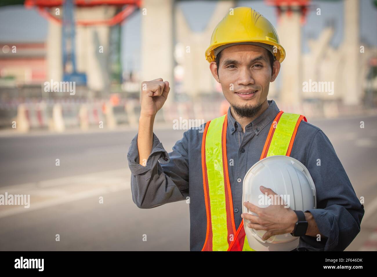 Engineer holding helmet on site Road construction For the development