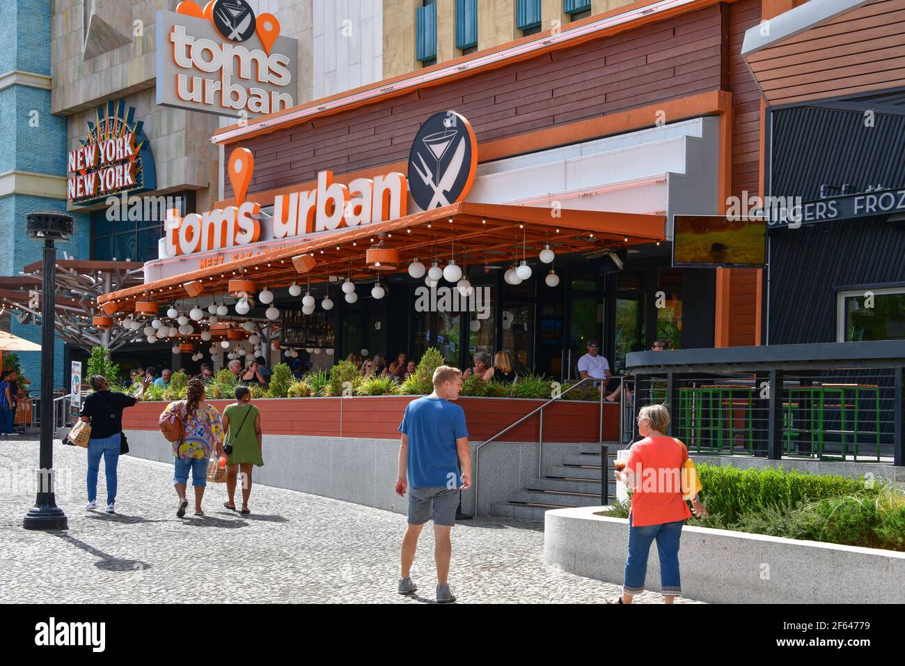 Nevada, USA 10-01-18 A group of tourists walk in front of the modern Tom's Urban restaurant located in the New York-New York Las Vegas Hotel Stock Photo