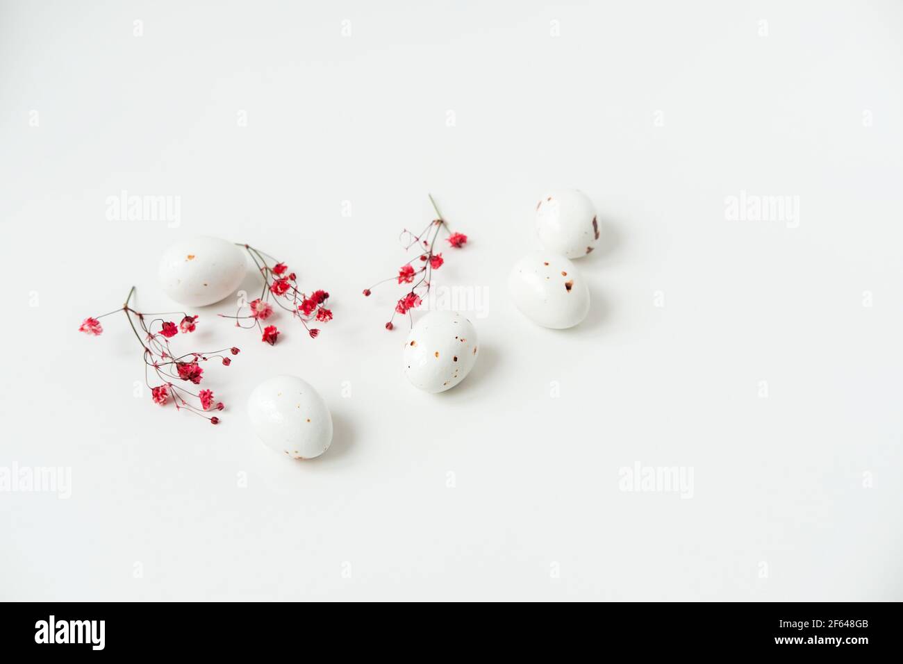 Easter minimal composition with eggs and flowers on the white ...