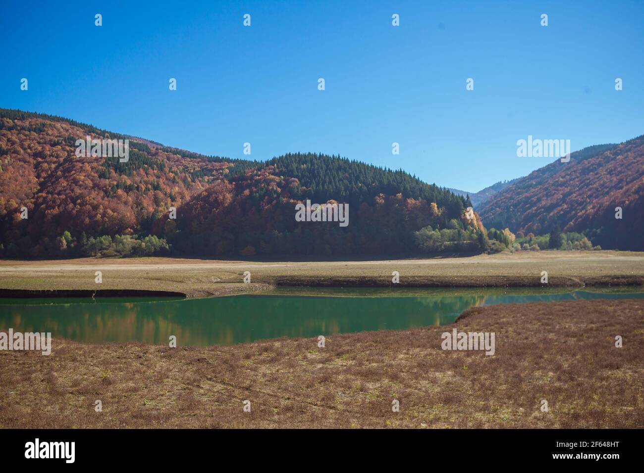 Autumn landscape in the mountains with river and colorful trees on ...