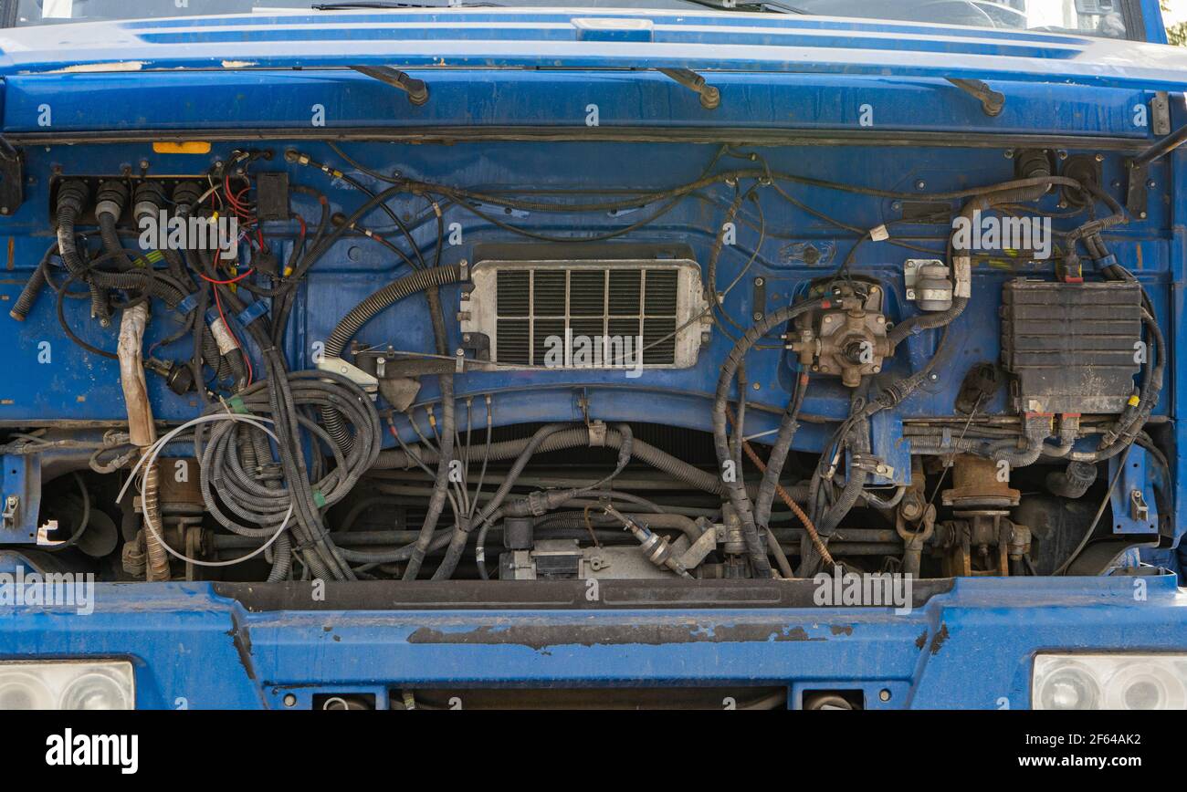 The truck cab is blue with the hood up. Truck repair. Service and