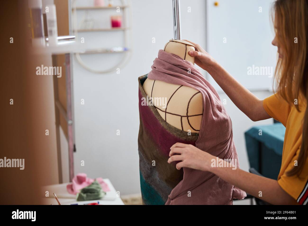 Female child using mannequin in sewing Stock Photo Alamy