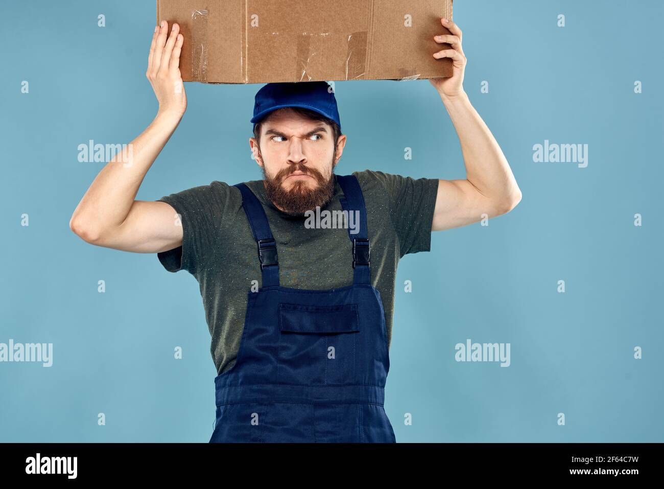 Man in working uniform loading service and delivery blue background ...