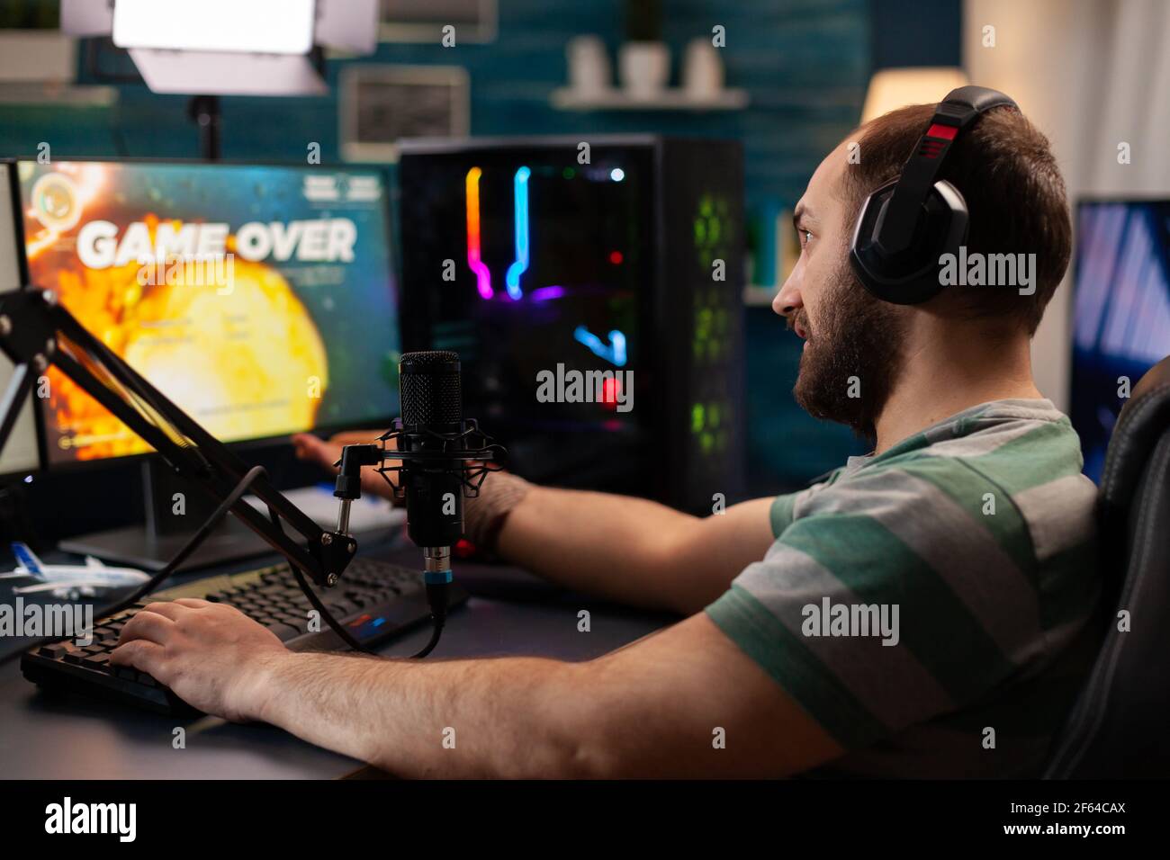 Streamer losing virtual videogames competition use professional setup with streaming chat open. Online cyber performing during gaming tournament using technology network wireless Stock Photo