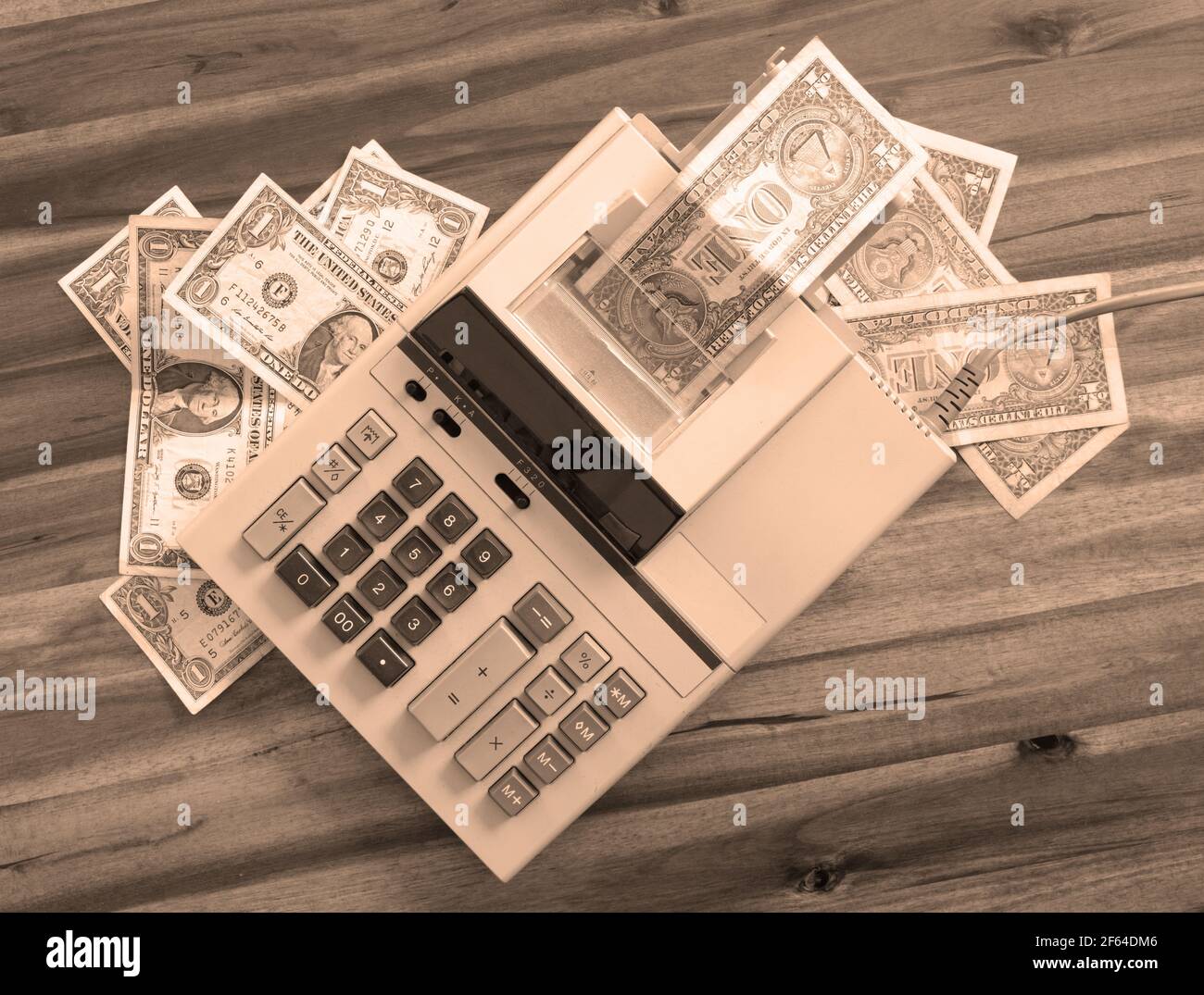 Old fashioned calculator and dollars on a desk Stock Photo
