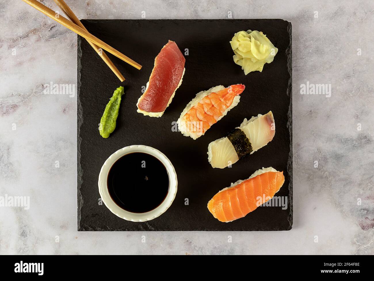 Japanese sushi food. Nigiri with tuna, salmon, shrimp served with soy sauce, ginger, and wasabi.  Stock Photo