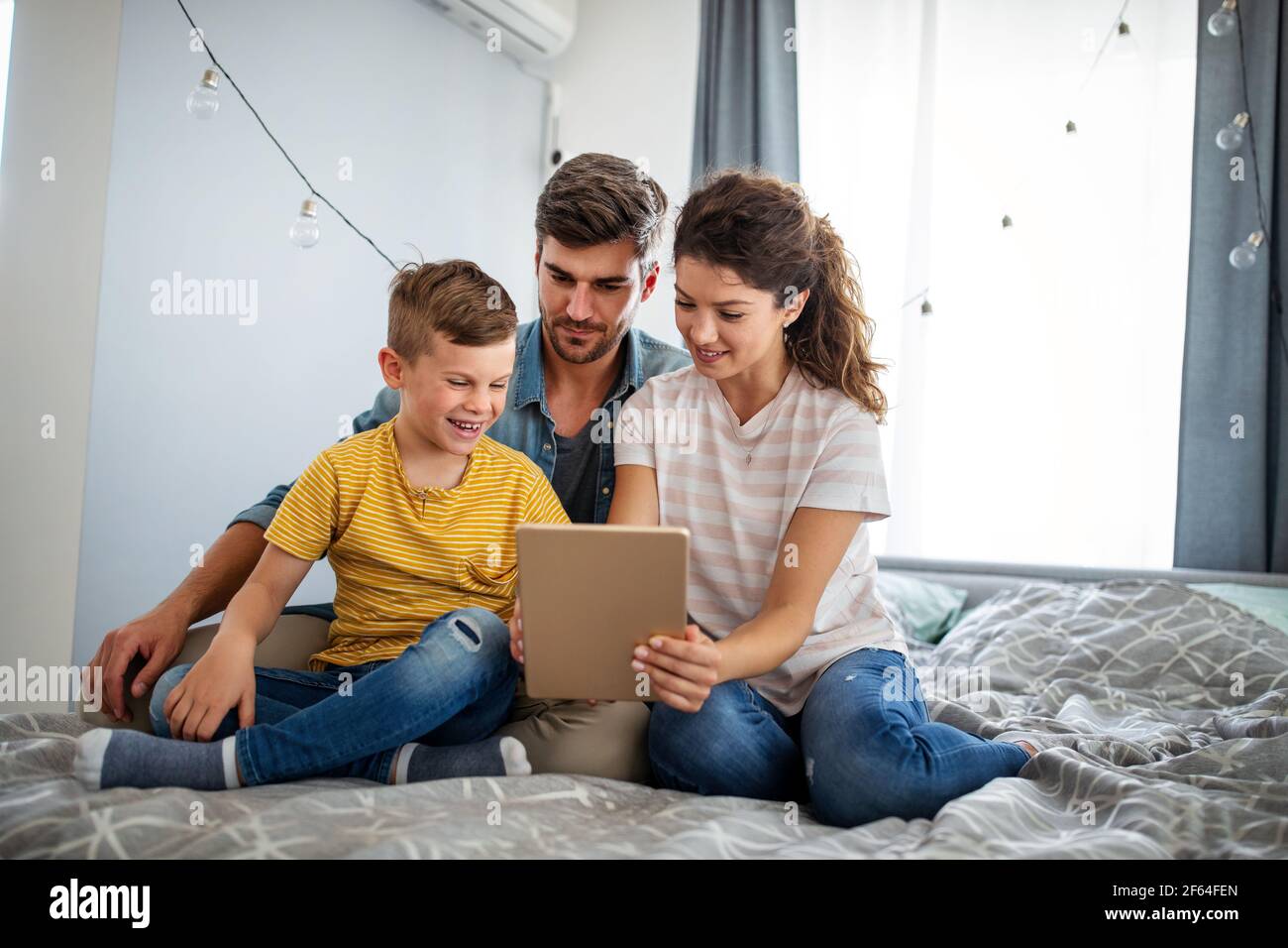 Happy modern family using computer together at home Stock Photo - Alamy