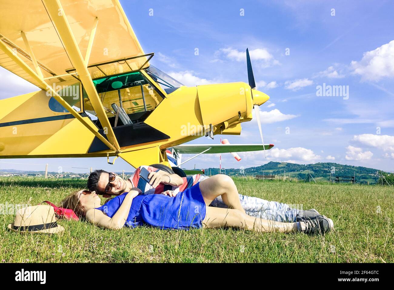 Relaxed couple of lovers having a rest during charter airplane excursion - Wanderlust concept of alternative people lifestyle traveling around world Stock Photo