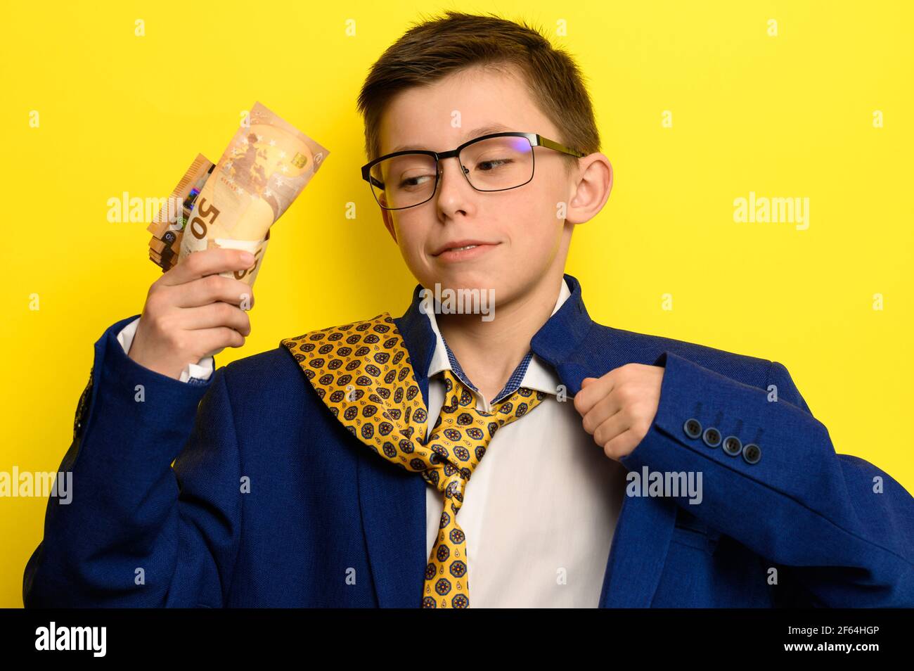 Successful child of successful parents, a boy counts the money earned