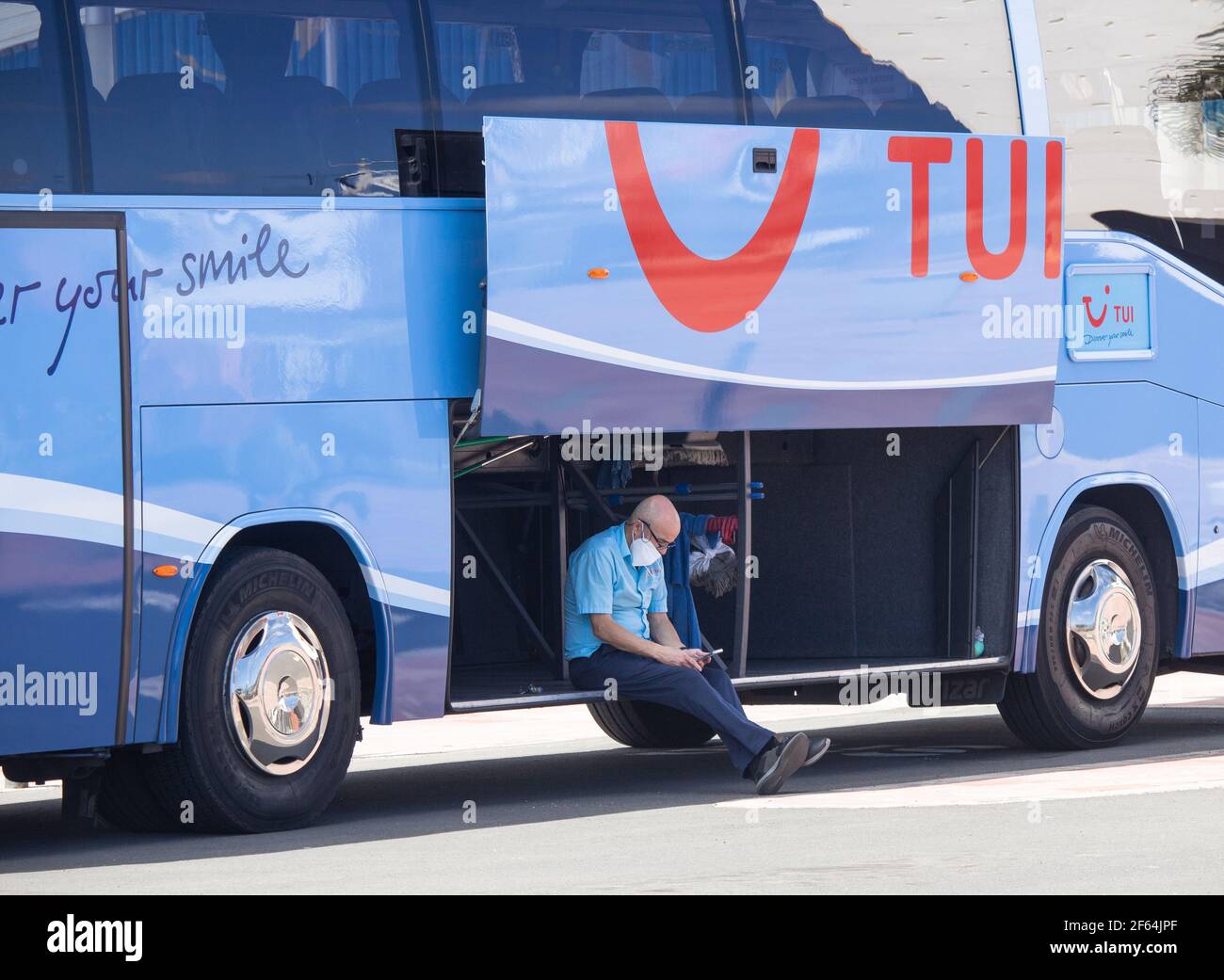 Tui coach, bus driver wearing face mask, covering in Spain Stock Photo