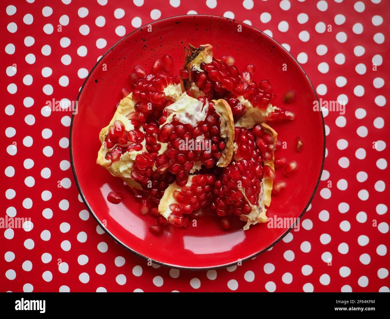 Pomegranate and seeds in a red plate Stock Photo