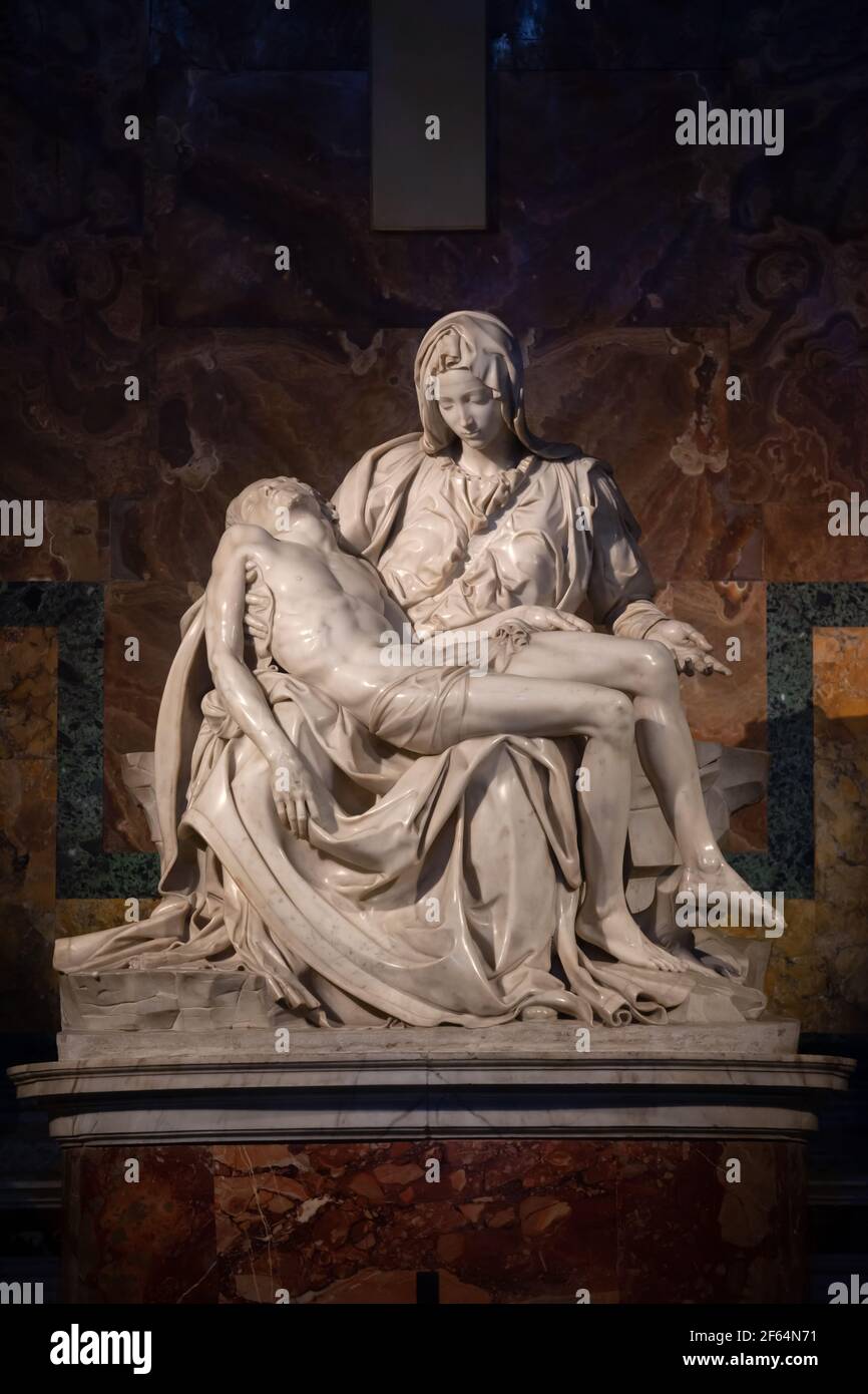 Jesus in the lap of Mother Mary after his crucifixion. Pieta by Michelangelo in Saint Peter Basilica in Vatican, striking Renaissance masterpiece scul Stock Photo
