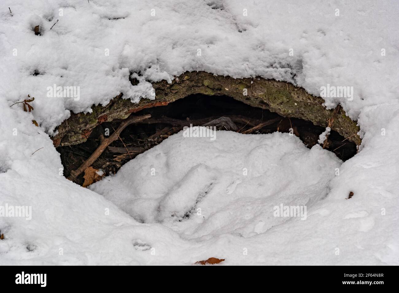 Snow covered surface with hole in concrete structure Stock Photo