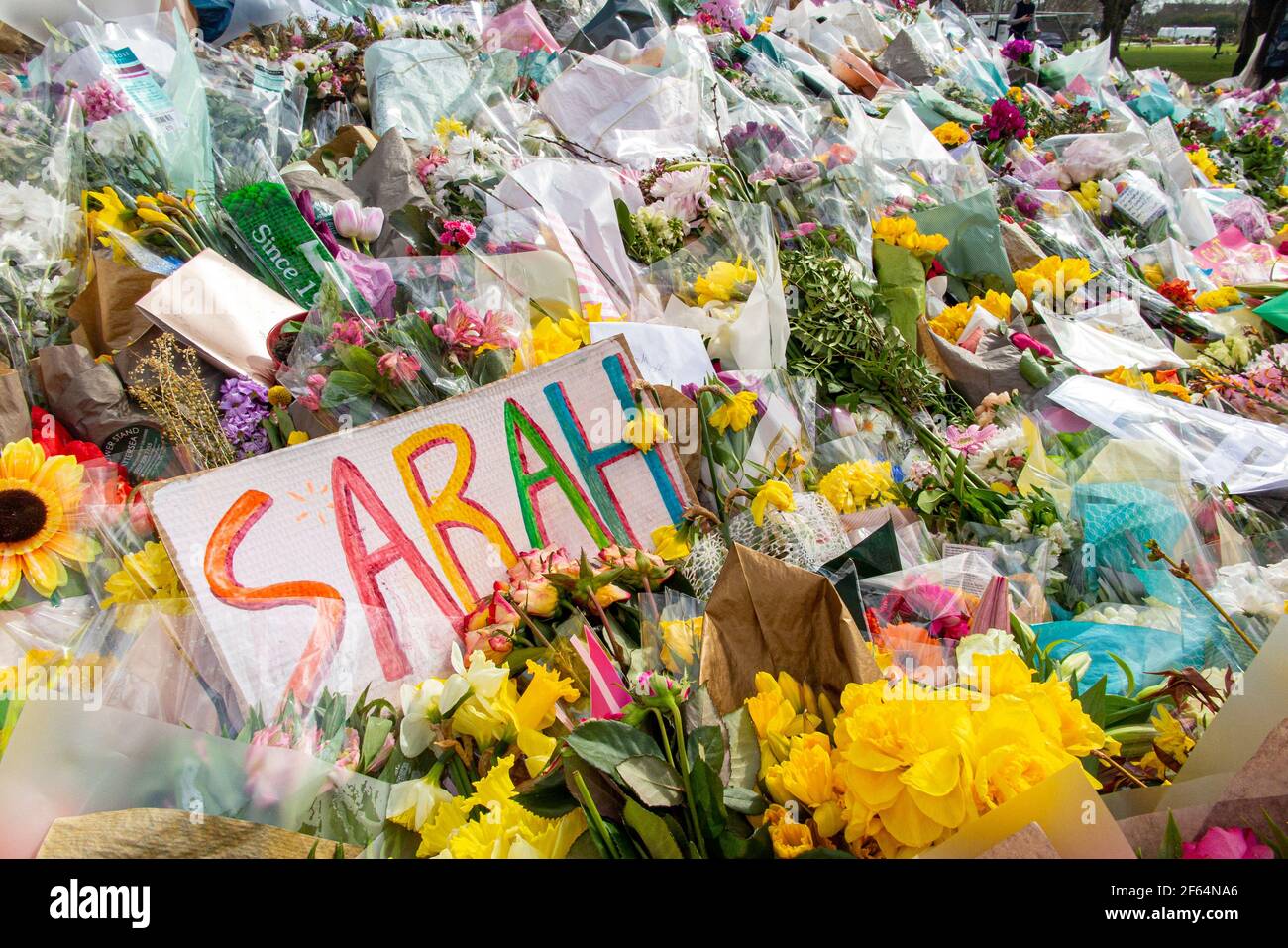 Clapham Common, London - shortly after the vigil and arrests by the poice, calmness prevails where flowers are laid in memory of Sarah Everard. Stock Photo