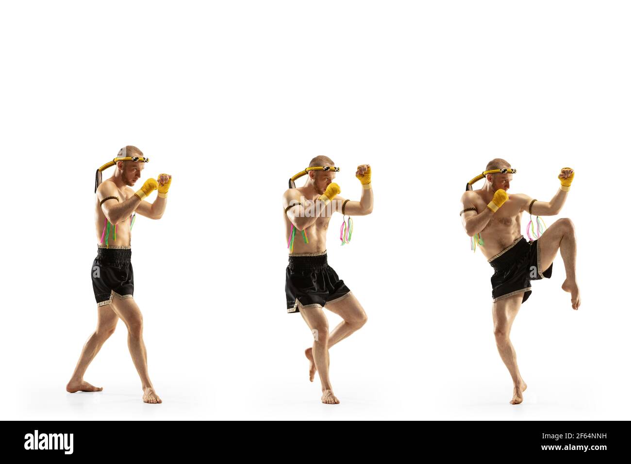Young man thai boxer on white background in motion of step to step knee ...