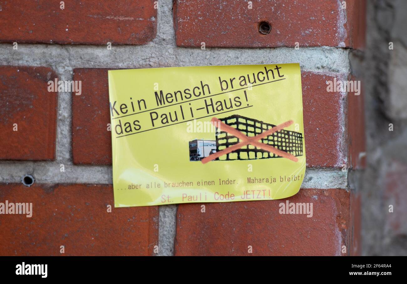 Hamburg, Germany. 30th Mar, 2021. A sticker with the inscription Kein Mensch braucht das Pauli-Haus! is stuck on a wall of the Maharaja restaurant. The operator of the Indian restaurant Maharaja at Hamburg's Rindermarkthalle has to vacate her premises to make room for the new building project Paulihaus. Credit: Daniel Reinhardt/dpa/Alamy Live News Stock Photo