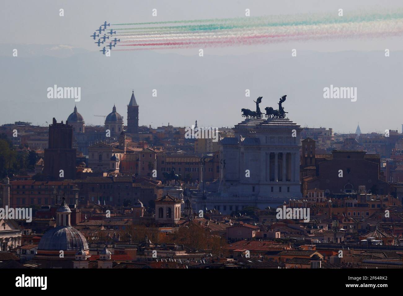 Italy's acrobatic Air Force squadron blaze the colours of the Italian flag over the capital as they celebrate the 98th anniversary of the establishment of the Air Force, in Rome, Italy, March 30, 2021. REUTERS/Guglielmo Mangiapane Stock Photo