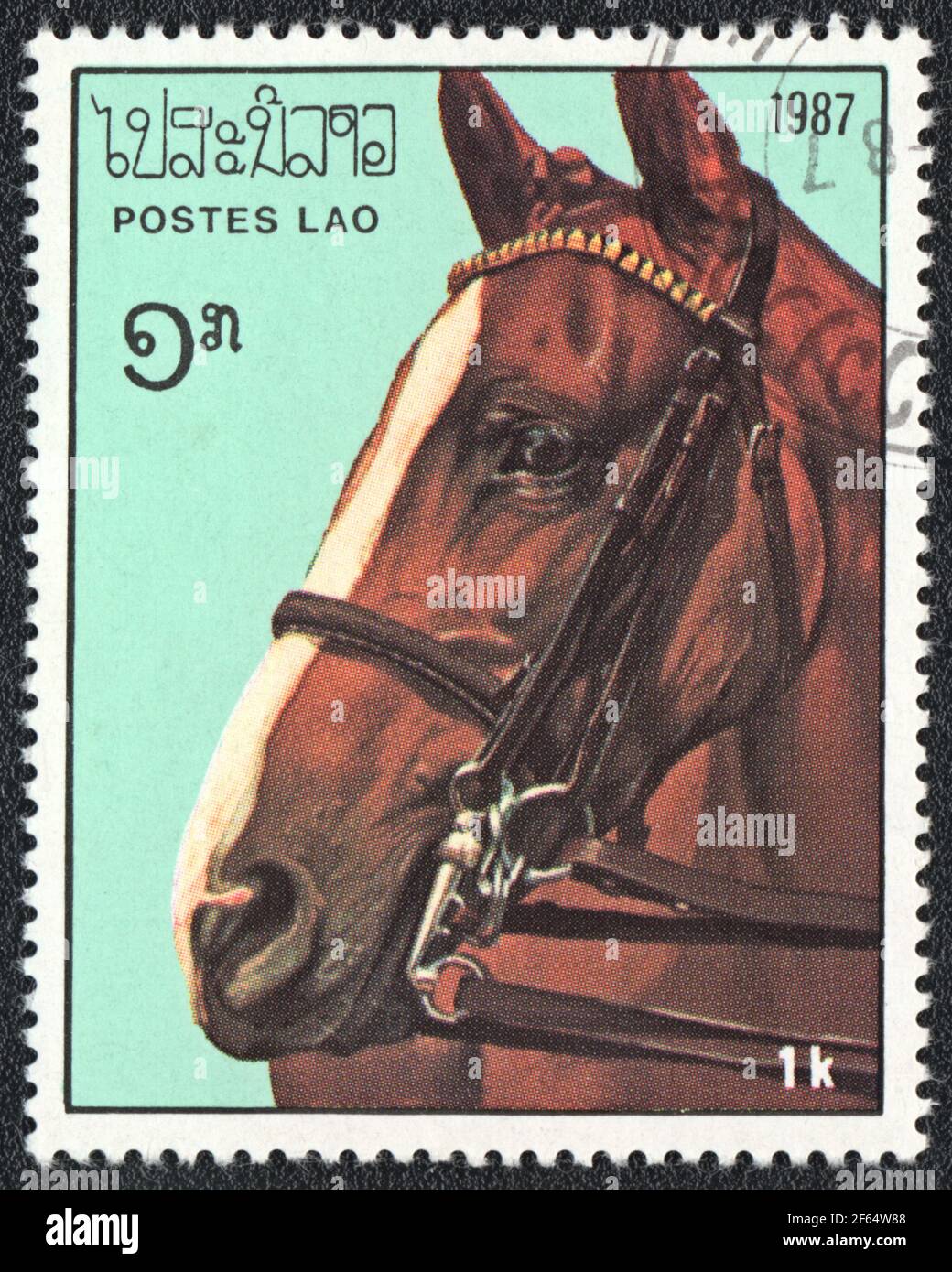 A postage stamp printed in Laos shows a brown with white horse (Equus ferus caballus) from series: Thoroughbred Horses, circa 1987 Stock Photo