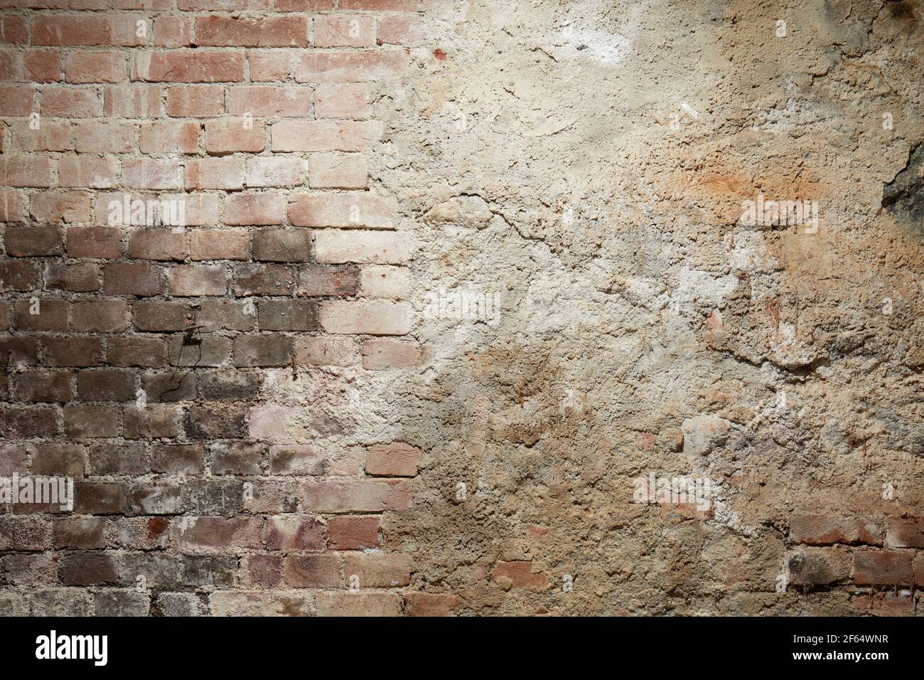 Old brick and cement wall with black burned part Stock Photo