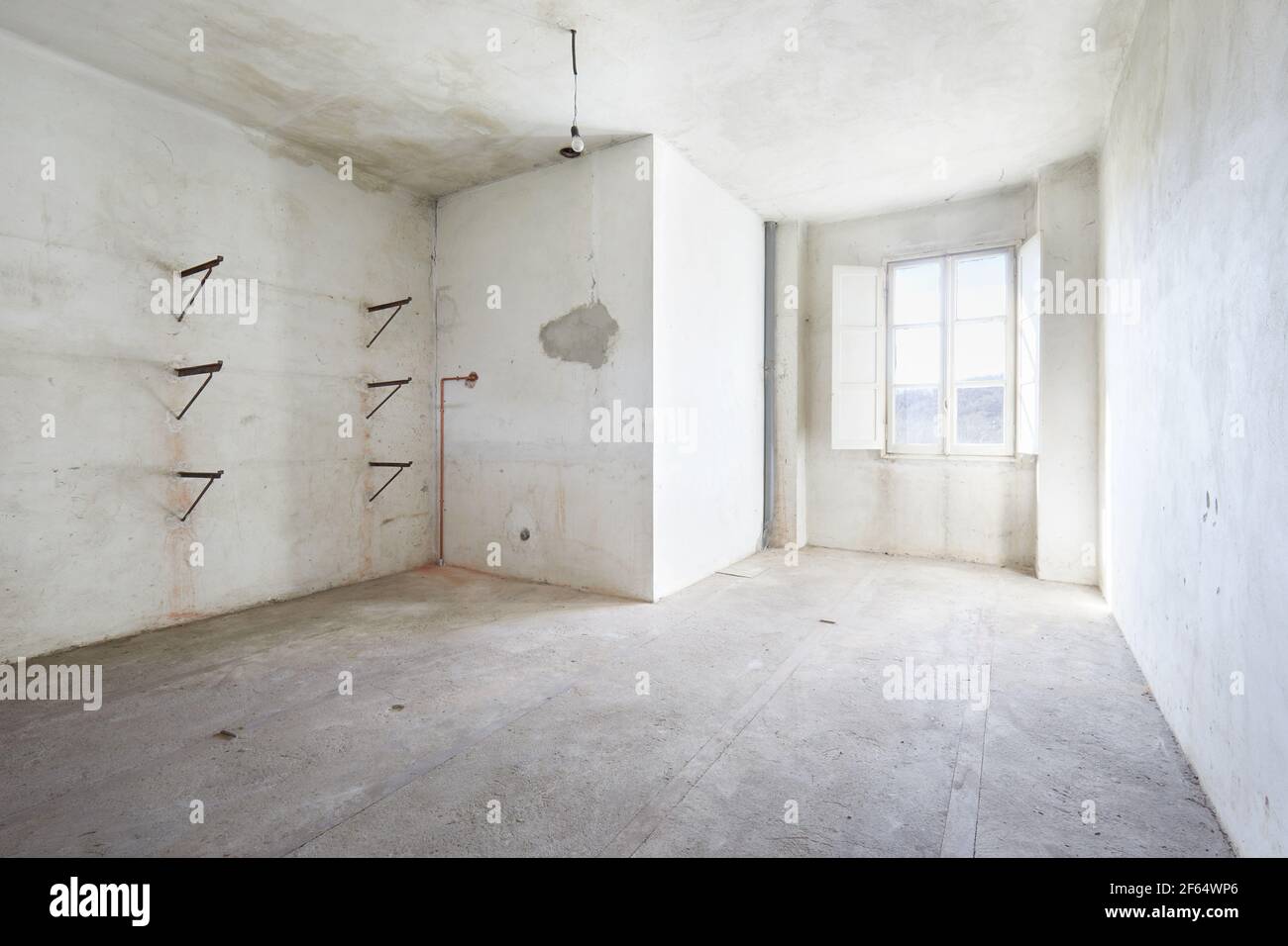 Empty, dirty room in old house, white walls Stock Photo