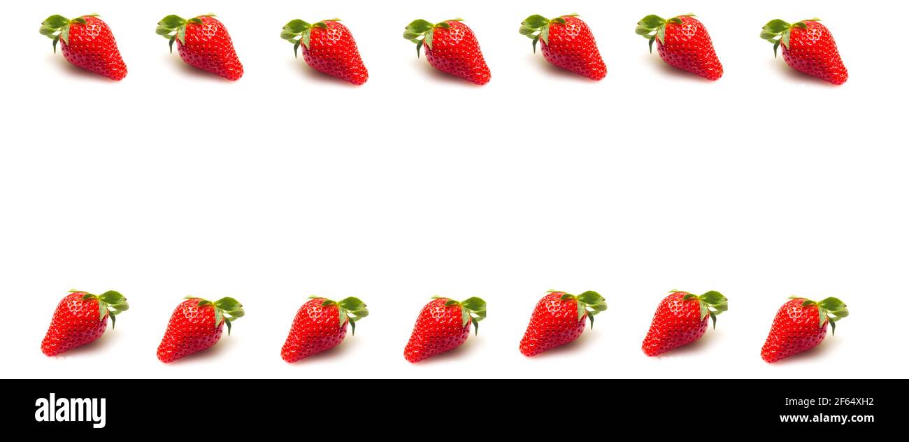 Close-ups of seasonal strawberries on white background. Strawberries with their green leaves and water drops. Macro photograph of strawberry fruit see Stock Photo