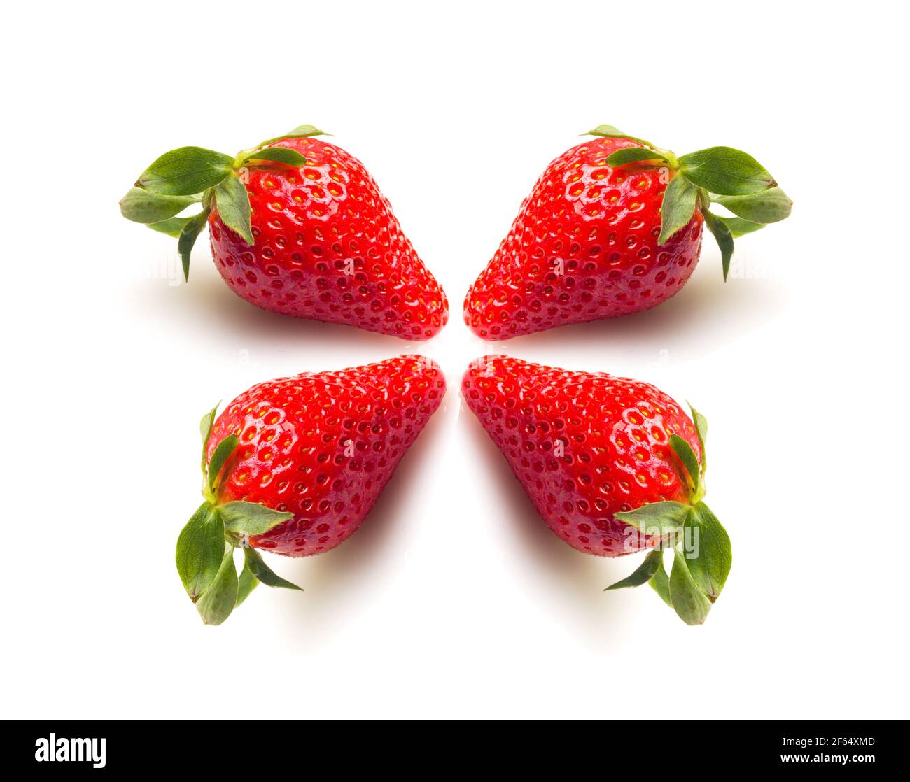 Close-ups of seasonal strawberries on white background. Strawberries with their green leaves and water drops. Macro photograph of strawberry fruit see Stock Photo