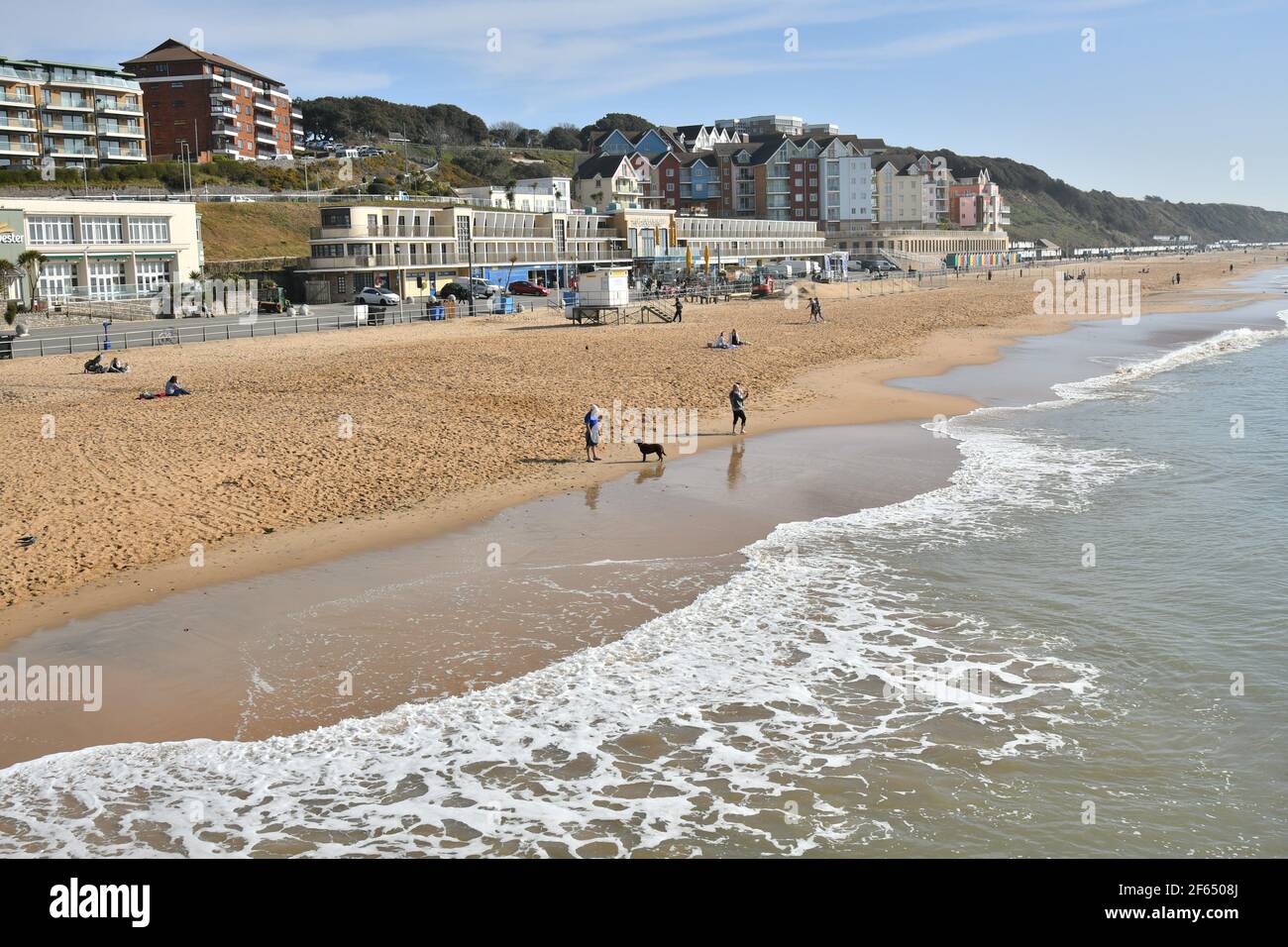 Boscombe, Bournemouth, Dorset, UK, 30th March 2021, Weather. An early spring heatwave coincides with the relaxing of coronavirus restrictions which now allow up to six people from two households to meet outdoors. People head out to the beach as temperatures are widely expected to reach or exceed 20 degrees, several degrees above the average for late March. Credit: Paul Biggins/Alamy Live News Stock Photo