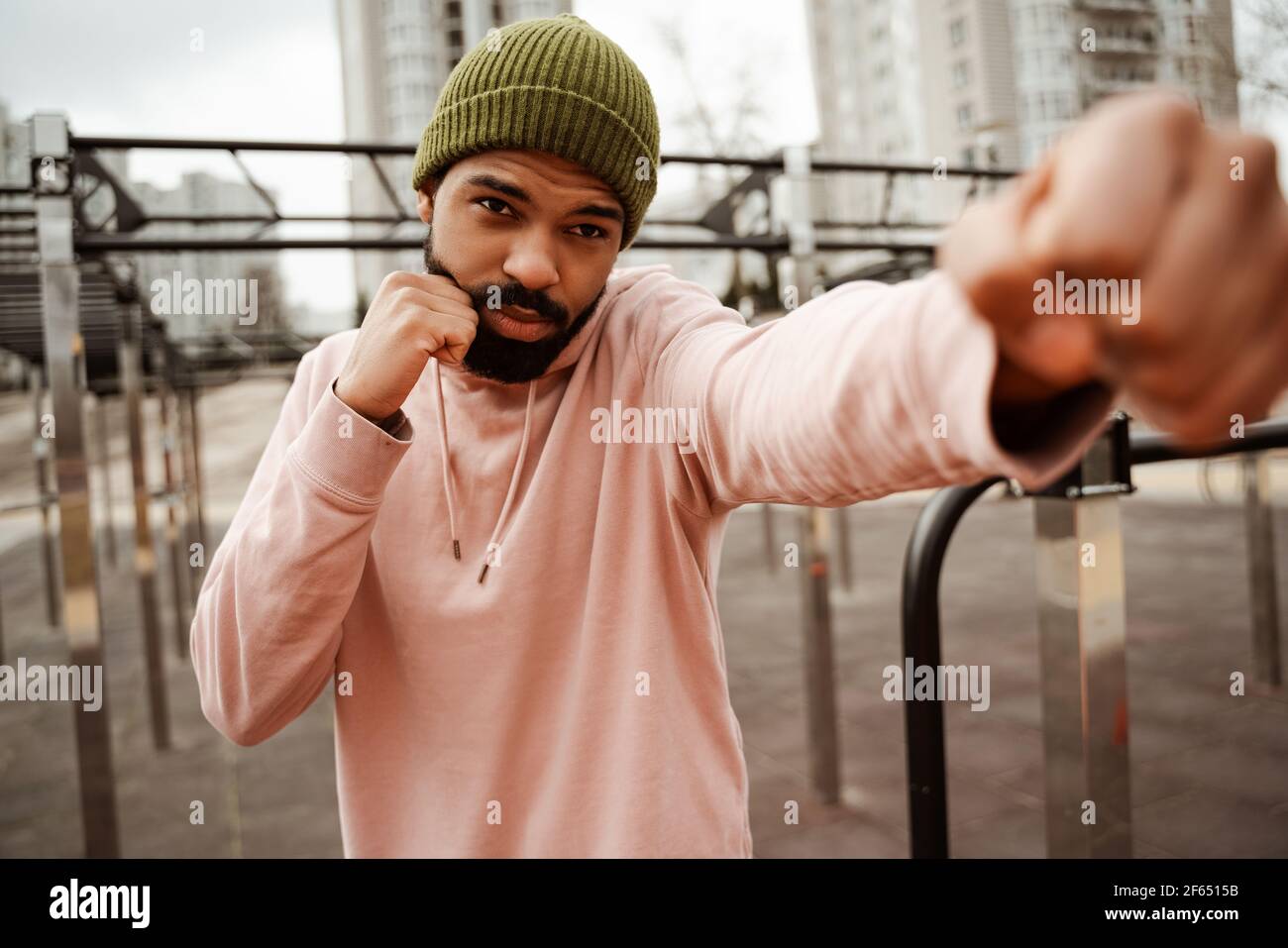 young african american boxer warming up outdoors, blurred foreground Stock Photo