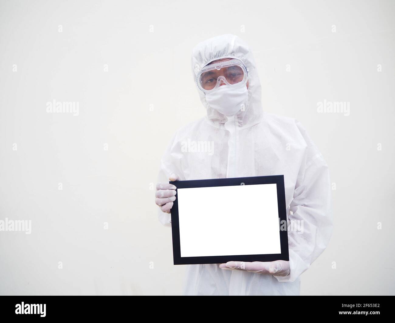 Asian doctor or scientist in PPE suite uniform. holding white screen square black frames for your design. coronavirus or COVID-19 concept isolated whi Stock Photo