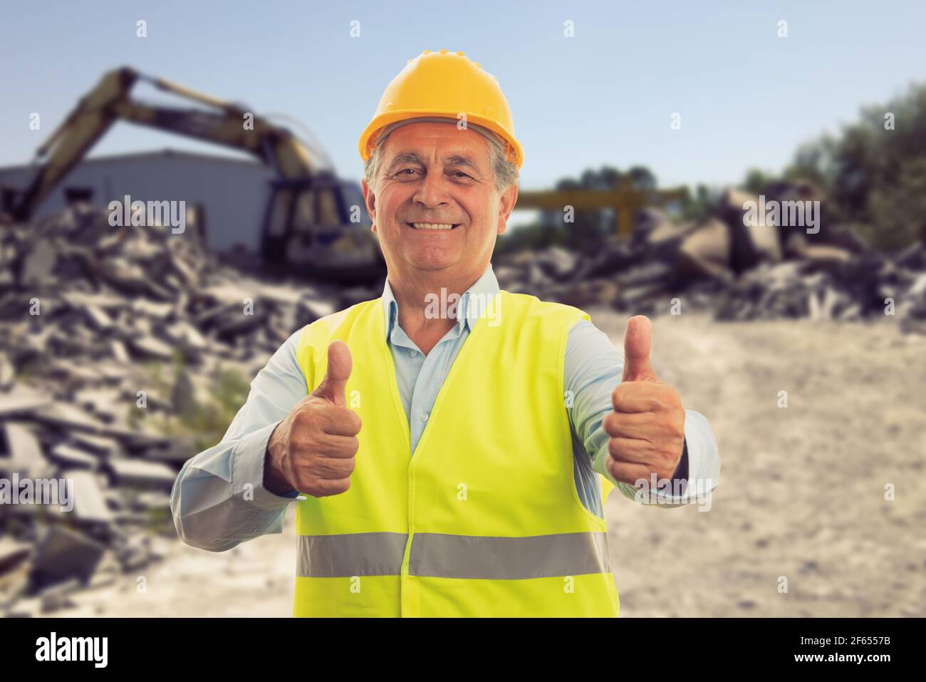 Cheerful old male builder making double like gesture using thumbs-up ...